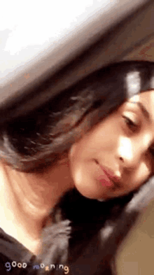 a close up of a woman 's face with a blurred background .