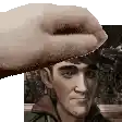 a close up of a person 's hand holding a man 's face .