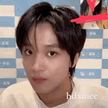 a close up of a person 's face with the name hdxinee written on the bottom