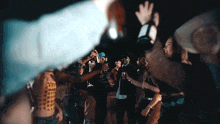a group of people dancing in a dark room