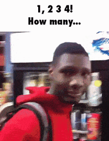 a man in a red jacket is standing in front of a vending machine with the words 1,234 how many written above him