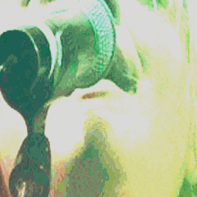 a blurry picture of a person holding a bottle