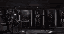 a man in a superhero suit is standing on a platform in front of a group of soldiers with guns