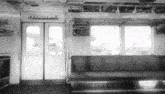 a black and white photo of an empty train with a sign above the doors that says ' 88 ' on it