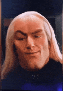 a close up of a man 's face with a serious look on his face