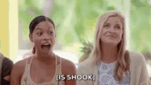 two women are sitting next to each other with their mouths open and one woman is saying `` is shook '' .