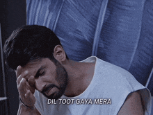 a man with a beard is holding his head and the words dil toot gaya mera are above him
