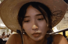 a woman wearing a straw hat with the word amour on it