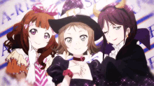 three anime girls are posing for a picture and one has horns on her head .