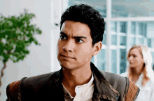 a man with a serious look on his face looks to the side