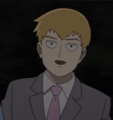 a man in a suit with a pink tie making a funny face