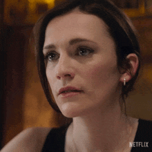 a close up of a woman 's face with the word netflix on the bottom right
