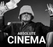 a black and white photo of a man wearing a hat with the words absolute cinema above him