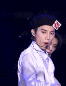 a man wearing a black beret with a red white and blue stripe on it