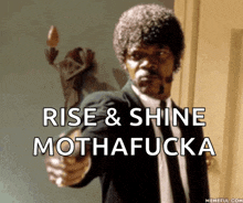 a man in a suit and tie pointing a gun with the words rise & shine mothafucka written below him