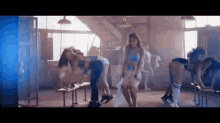 a group of women are dancing in a gym in front of a window .