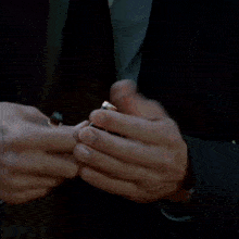 a close up of a person 's hand holding a black pen