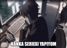 a person is sitting at a desk in front of a computer and a keyboard .