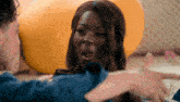 a woman with a surprised look on her face is being held by a man in a blue shirt