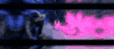 a blurred image of a person in a blue and pink background