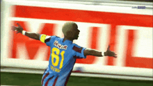 a soccer player with the number 61 on his jersey celebrates