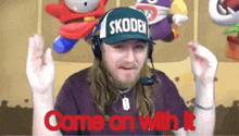 a man wearing headphones and a hat with the word skoden on it