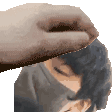 a hand is holding a person 's head in a pixel art .