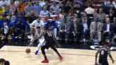 a basketball player with the number 13 on his jersey dribbles the ball
