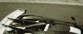 a black and white sports car is driving on a road