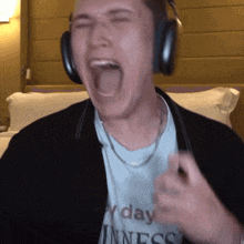 a man wearing headphones and a t-shirt that says every day