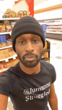 a man wearing a black t-shirt that says jumanne strugged