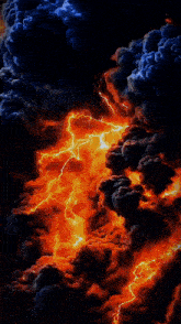 a man and a woman are posing for a picture with fire and smoke behind them