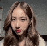 a close up of a woman 's face with brown hair and red lips