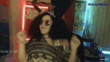 a woman is dancing in front of a sign that says " happy halloween "