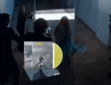 a group of people are gathered around a yellow record that says jrc on it