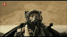 a man wearing a helmet and goggles is flying in a plane
