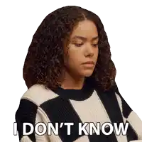 a woman with curly hair is wearing a sweater that says i do n't know