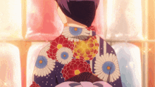 a woman is wearing a blue kimono with flowers on it