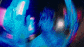 a blurry image of a person 's face with a blue light behind them