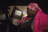 a woman is sitting in the back seat of a car .