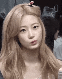 a woman with blonde hair is making a funny face