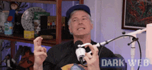 a man is sitting in front of a microphone with the words dark web written on the bottom