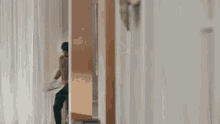 a man is reading a newspaper in a hallway .