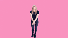 a woman is dancing in front of a pink background with the words thank you