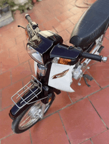 a black and white honda motorcycle is parked on a tiled floor
