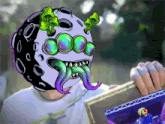 a person holding a picture of a man with a helmet on their head