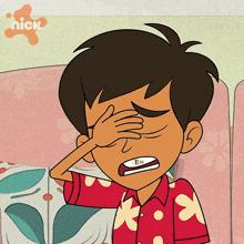 a cartoon boy covering his eyes with his hand with a nick logo in the background