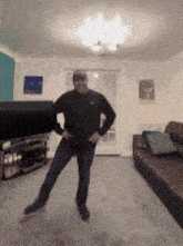 a man is dancing in a living room with a couch in the background