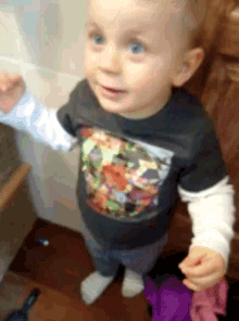 a young boy wearing a t-shirt with a cartoon character on it