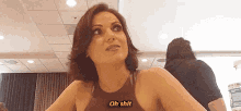 a woman is sitting at a table in a room and talking to someone .
